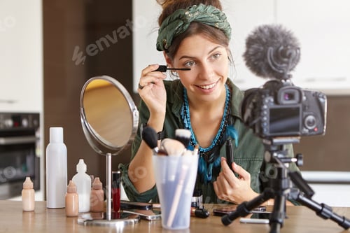Preview: Successful celebrity woman vlogger recording make up video tutorial for her subscribers on social me