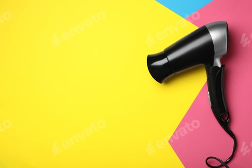 Vista previa: Hair dryer on color background, top view with space for text. Professional hairdresser tool