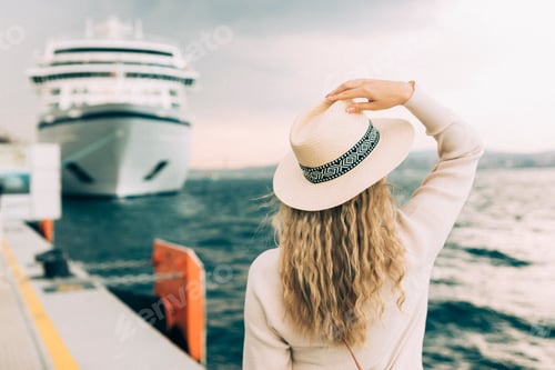 Preview: Woman tourist standing in front of big cruise liner, travel female