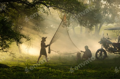 Preview: Local fisherman prepare a fishnet under the tree to capture fish in the lake