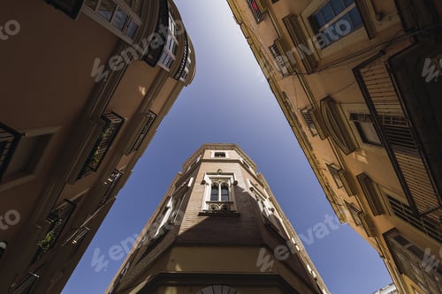 Preview: Worm's eye view of the streets featuring the tall buildings in Jerez, Spain