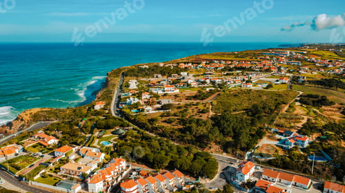 Preview: Aerial view of a small European town against blue sky and Atlantic Ocean. Drone view, European city