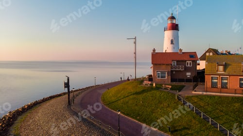 Preview: Urk Flevoland Netherlands sunset at the lighthouse and harbor of Urk Holland. Fishing village Urk