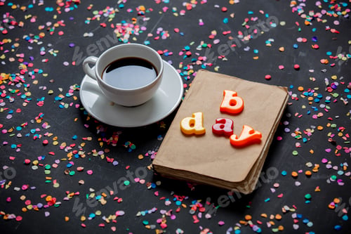 Preview: Cup of coffee and book with b day letters