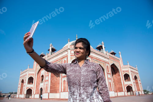 Preview: Young girl taking Photos in front of Humayun's Tomb, Delhi, India.