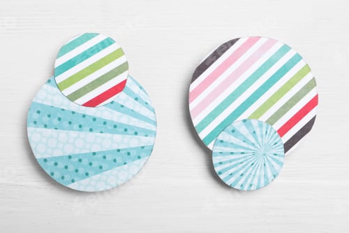 Preview: Big and small colorful paper circles on white wooden background, flat lay. Pareto principle concept
