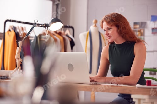 Preview: Female Student Or Business Owner Working In Fashion Using Laptop In Studio