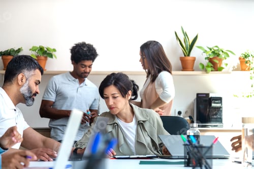 Preview: Group of multiracial colleagues working at the office. Coworkers standing on the background.