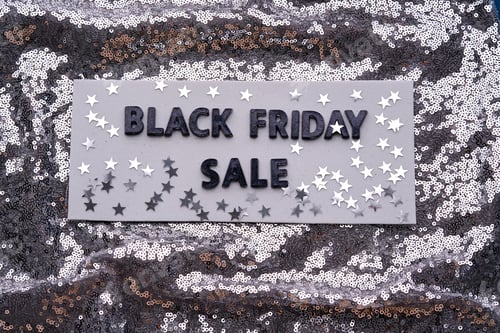 Preview: The inscription BLACK FRIDAY SALE on a shining background of silver sequins.