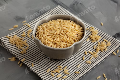 Preview: Raw Organic Orzo Pasta in a Bowl, side view.
