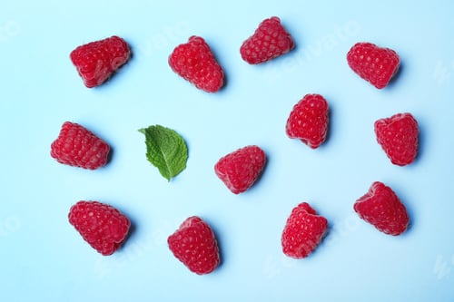 Preview: Flat lay composition with delicious ripe raspberries on blue background