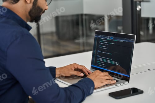 Preview: Busy businessman software developer working on computer in office. Over shoulder