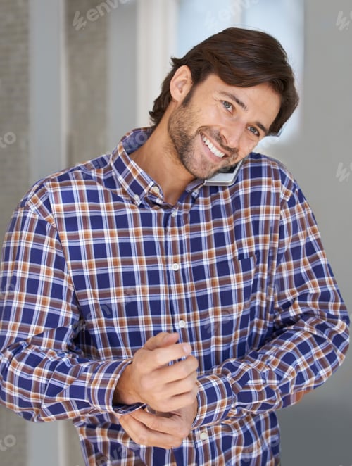 Preview: Man Smiling and Talking on Cellphone Indoors