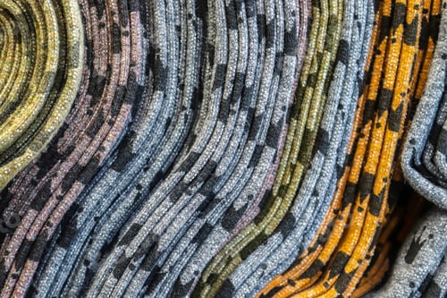 Preview: Closeup shot of surfaces and textures of folded fabrics cloth found at a fabrics market