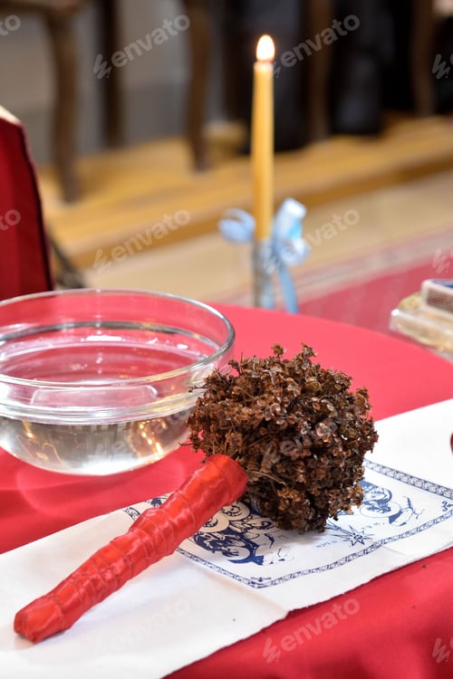 Preview: Closeup of the wedding celebration objects in the church, a bowl of water, white embroidered cloth