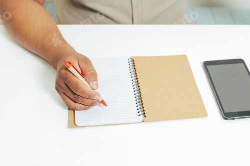 Preview: person writing in a note pad
