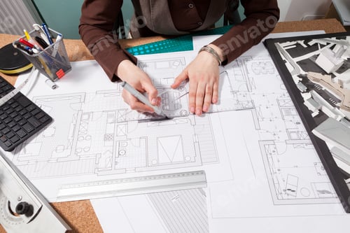 Preview: Close up of architect hands working on blueprints