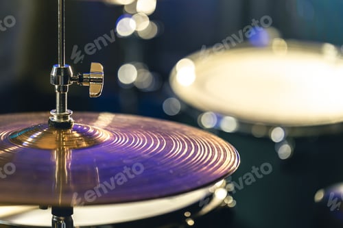 Preview: Drum cymbal close-up on a dark blurred background.