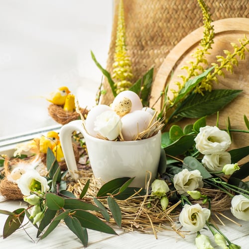 Preview: Easter egg in a nest with floral decoration near the window.