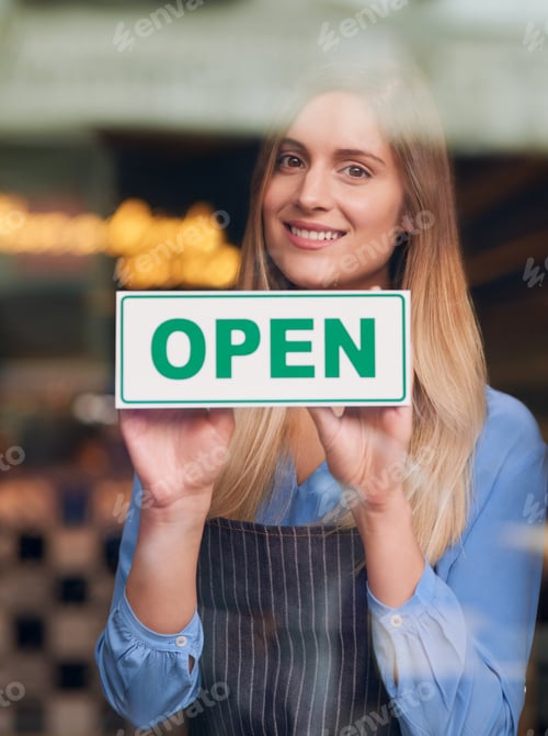 Preview: Were open for business. Cropped portrait of an attractive young woman opening up her coffee shop.