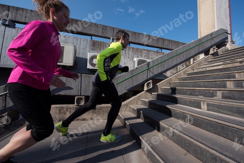 Preview: young couple jogging on steps