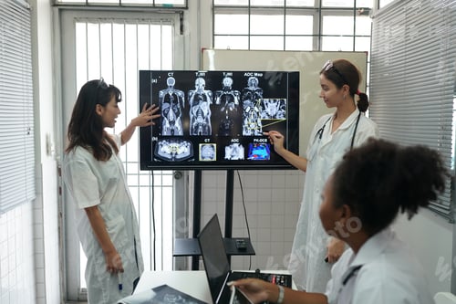 Preview: Group of doctors looking at X-ray on medical conference, discussing issues