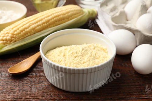 Preview: Different ingredients for corn bread. Corn flour, cob and eggs on wooden table, closeup