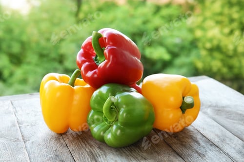 Preview: Raw ripe paprika peppers on table against blurred background