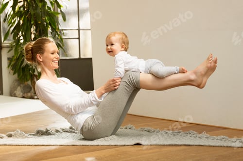 Preview: Woman Balancing Smiling Infant During Workout at Home