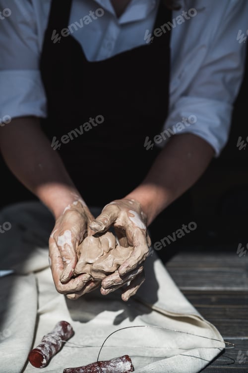 Preview: Close up picture of female ceramic artist arms in clay after making pottery
