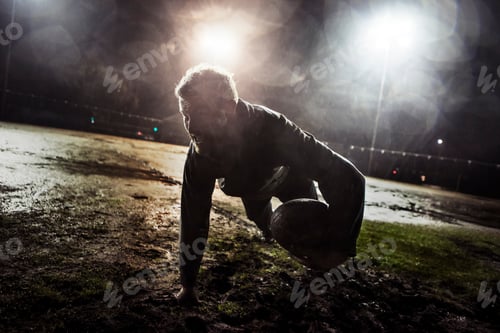 Preview: Determined athlete doing pushups at night under bright stadium lights