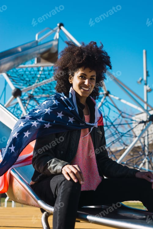 Preview: black woman with afro hair and an american flag.