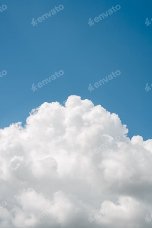 Preview: Vertical sky landscape, white fluffy clouds against clear blue sky