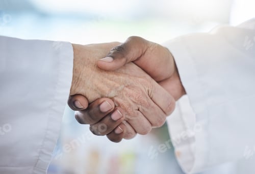 Preview: Closeup of hands of two doctors greeting each other with a handshake. African american doctor shaki