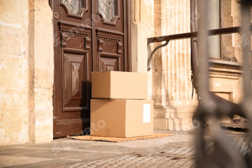 Preview: Delivered parcels on door mat near entrance
