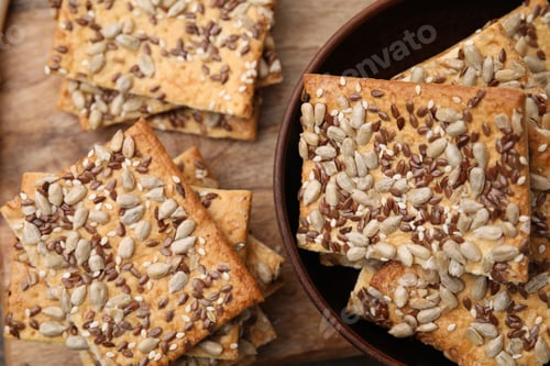 Preview: Cereal crackers with flax, sunflower and sesame seeds on wooden table, top view
