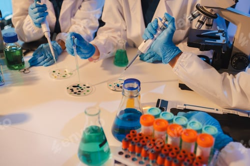 Preview: Scientist mixing chemical liquids in the chemistry lab.