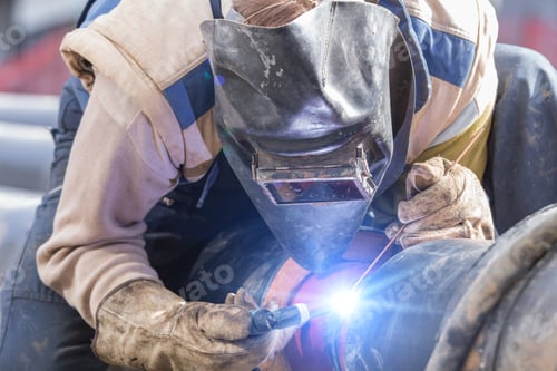 Preview: Construction Worker Welding Pipes On A Heavy Site.