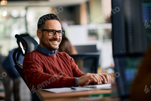 Preview: Happy entrepreneur working on desktop PC in the office.