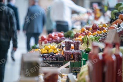 Preview: Outdoor food market with fruits, vegetables, and herbs arranged on wooden stalls