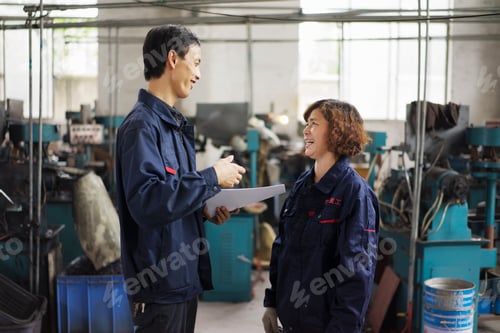 Preview: Supervisor explaining to worker in crane factory, Jiangsu Province, China
