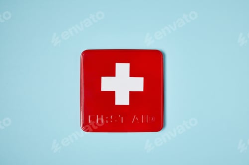 Preview: top view of red first aid kit box on blue surface