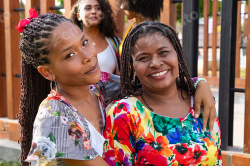 Preview: Two women snapping a selfie with friends laughing in the background