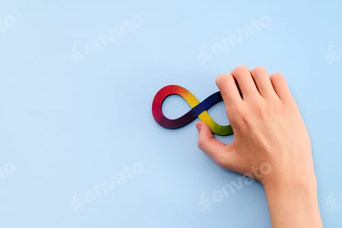 Preview: Autistic boy hands and rainbow eight infinity symbol. Autism awareness day symbol.