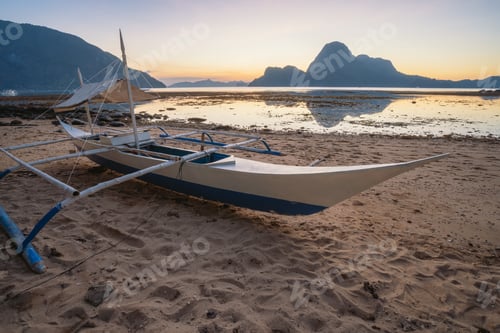 Preview: Tropical colorful sunset with a local banca boat in El Nido, Palawan - Philippines