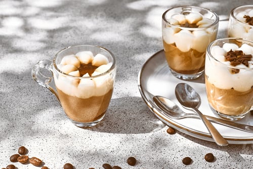 Preview: Traditional Italian dessert Tiramisu in glass cups on gray table.