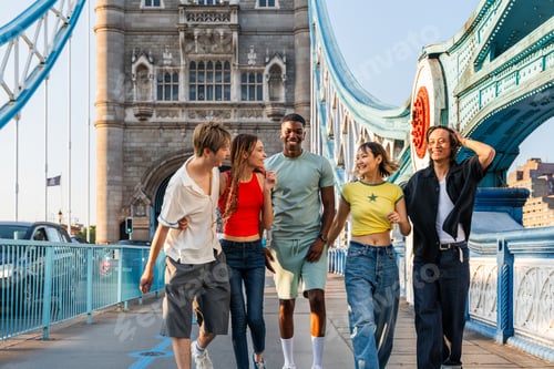 Preview: Multiracial group of happy young friends bonding in London
