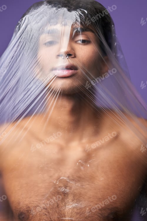 Preview: Transgender model with plastic bag on head portrait. Scared young man with claustrophobia problem