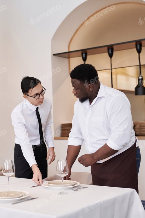 Preview: Headwaiter Helping Busser With Table Setting