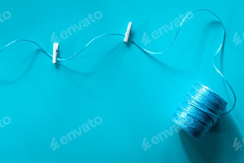 Preview: A ball of blue threads on a blue background, flat lay.